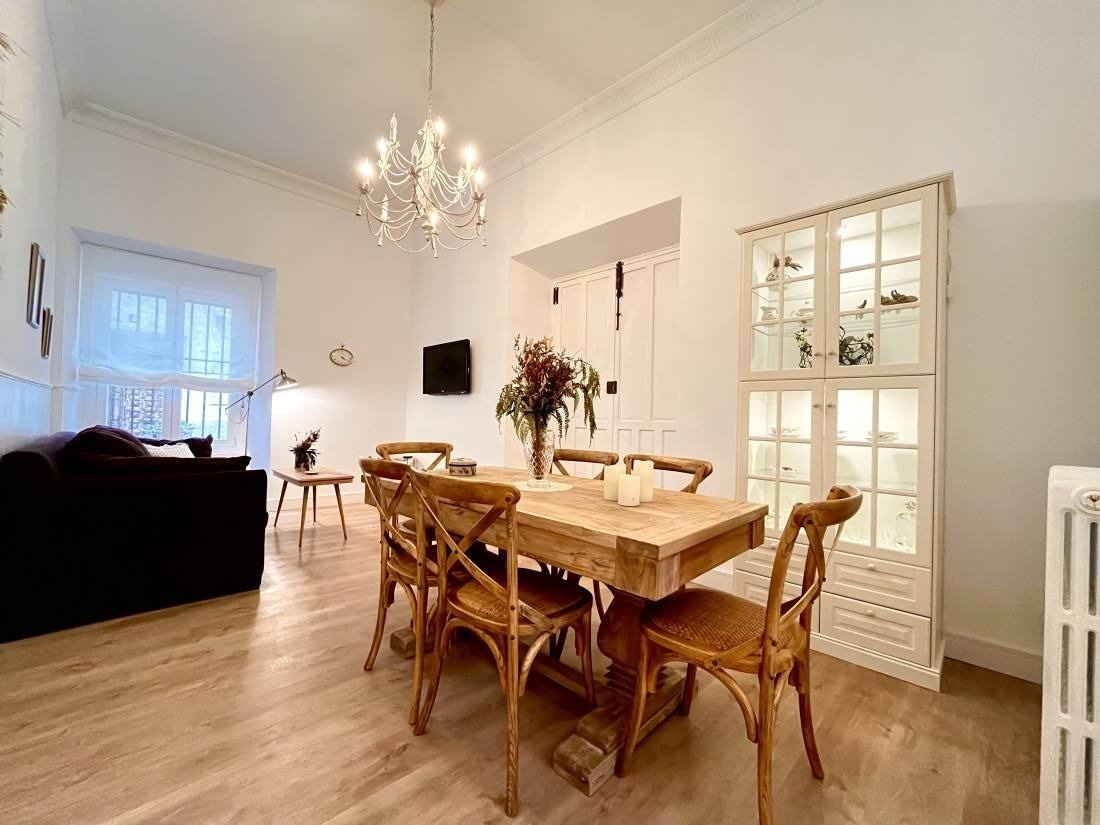 a dining room with a table and chairs and a chandelier