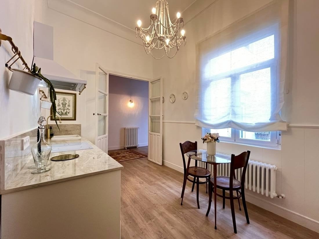 a kitchen with a table and chairs and a chandelier