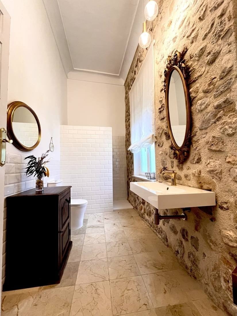 a bathroom with two sinks and two mirrors