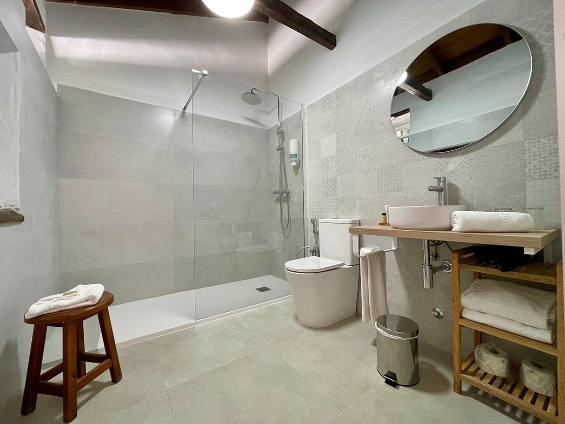 a bathroom with a toilet a sink and a mirror