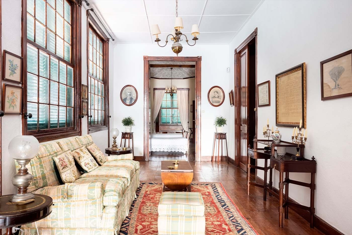 Elegant hotel living room with views of the inner courtyard and antique furniture.