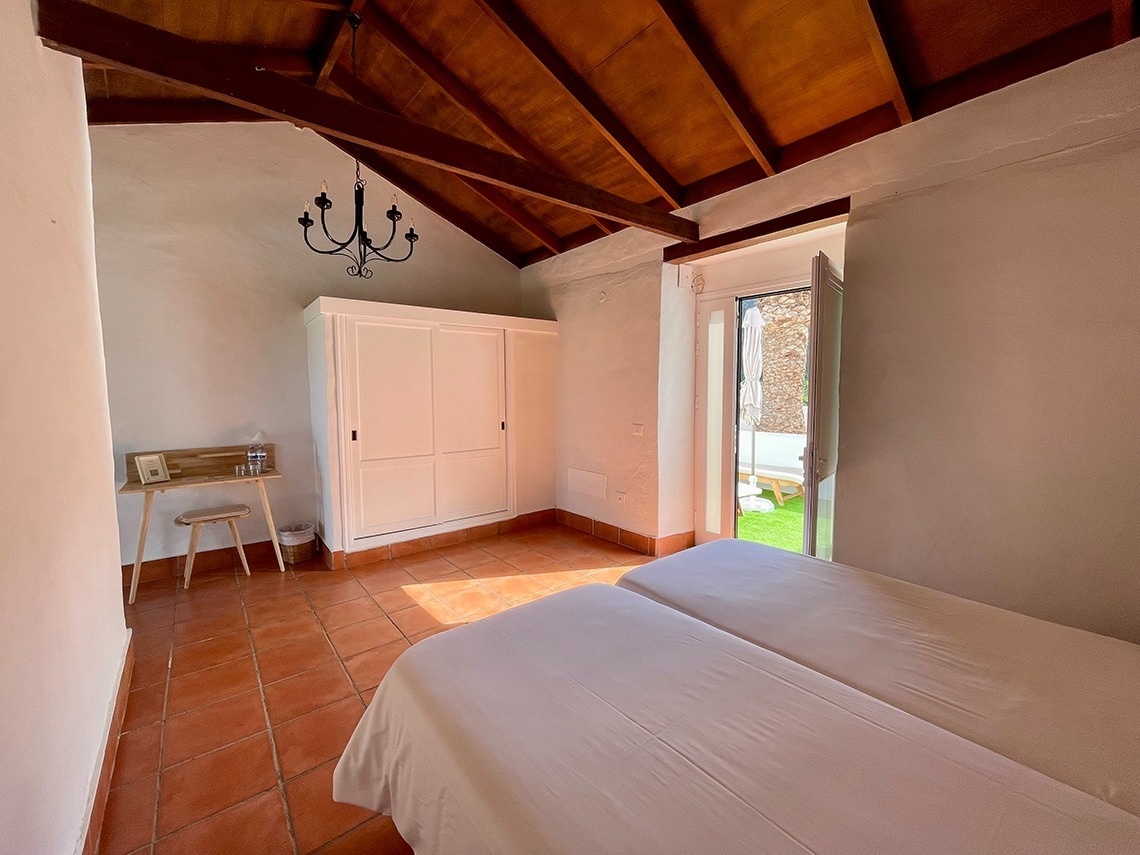 a bedroom with two beds a desk and a closet