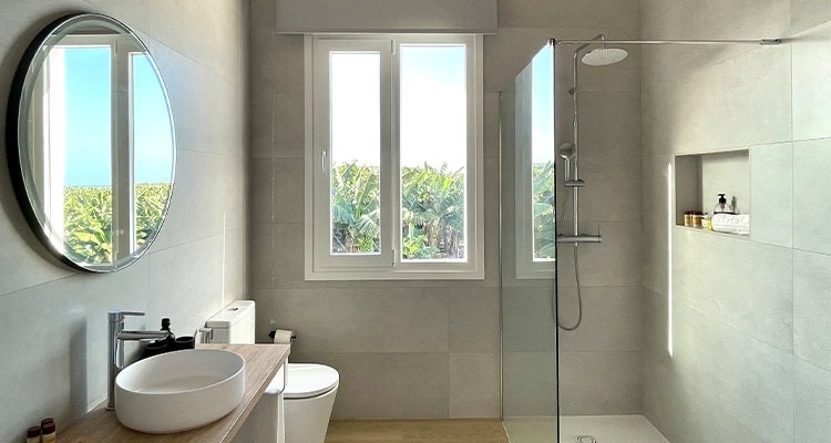 a bathroom with a toilet a sink and a shower