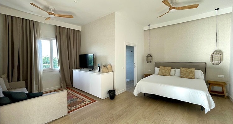 a bedroom with two beds and a sliding glass door