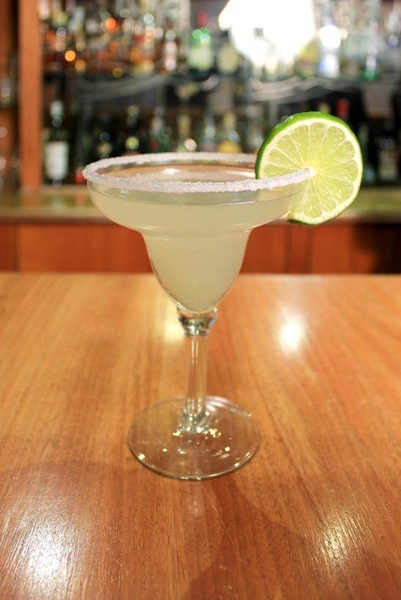 a margarita with a slice of lime on the rim