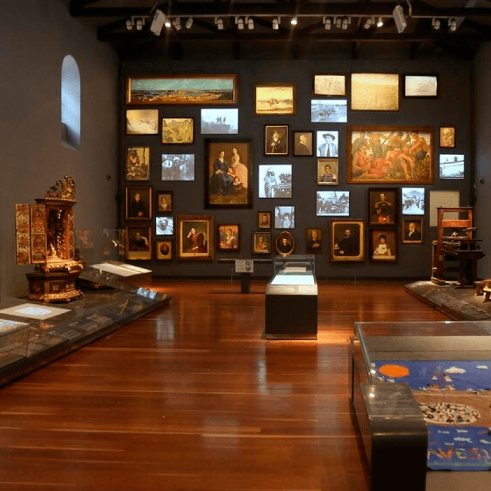 a museum with a lot of pictures on the wall