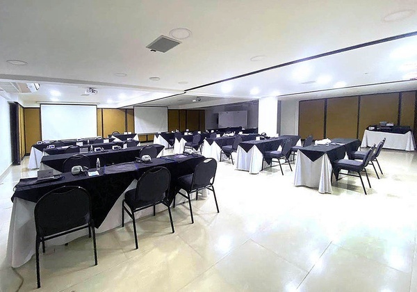 a large room with tables and chairs set up for a meeting