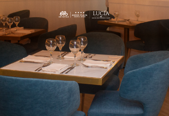una mesa con copas de vino y cubiertos en un restaurante llamado lucia