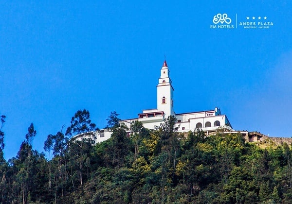a white building on top of a hill with the words andes plaza below it