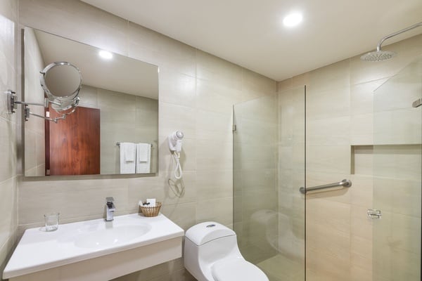 a bathroom with a toilet a sink and a mirror