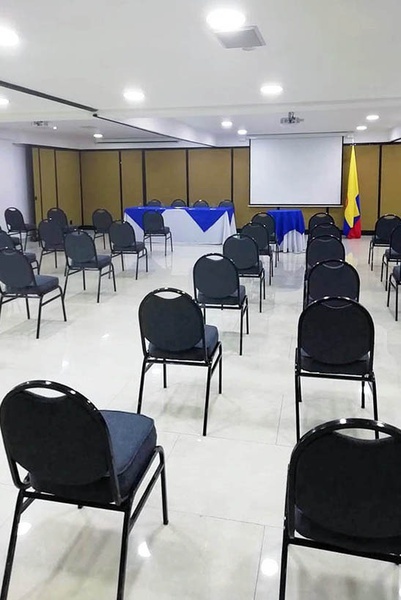 a conference room with chairs and a projector screen