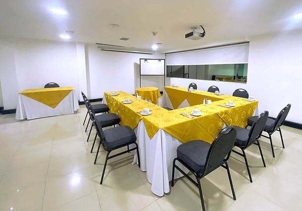 a conference room with tables and chairs and a projector