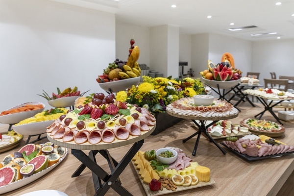 a buffet table with a variety of fruits and meats