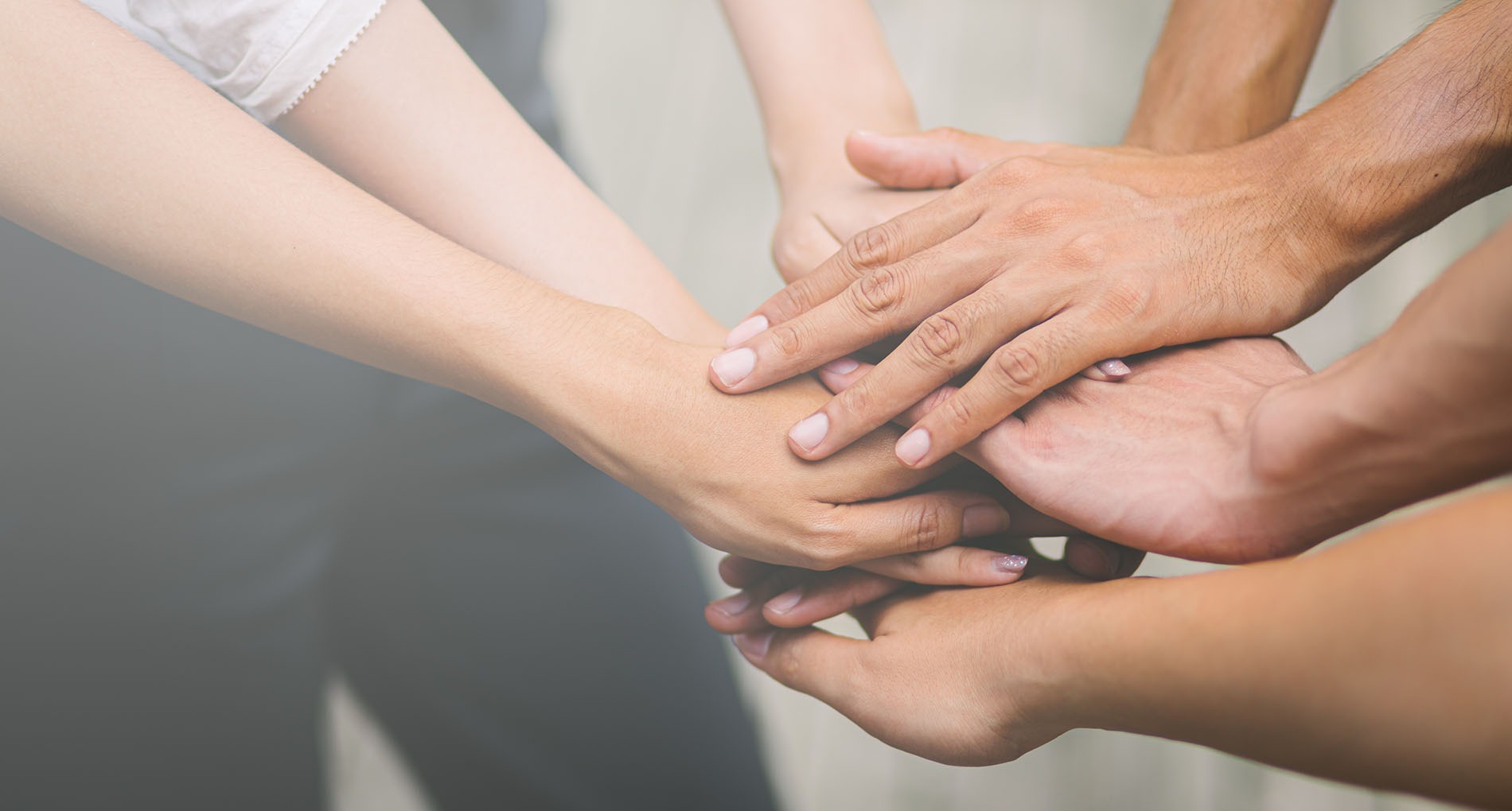 un grupo de personas pone sus manos juntas