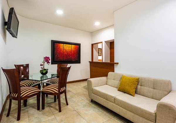 a living room with a couch a table and chairs