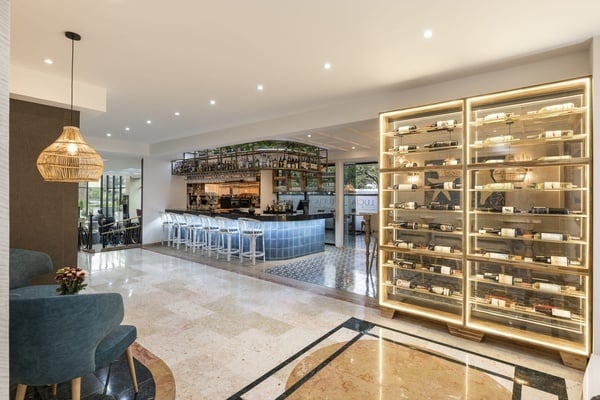 a restaurant with a bar and a wine display case