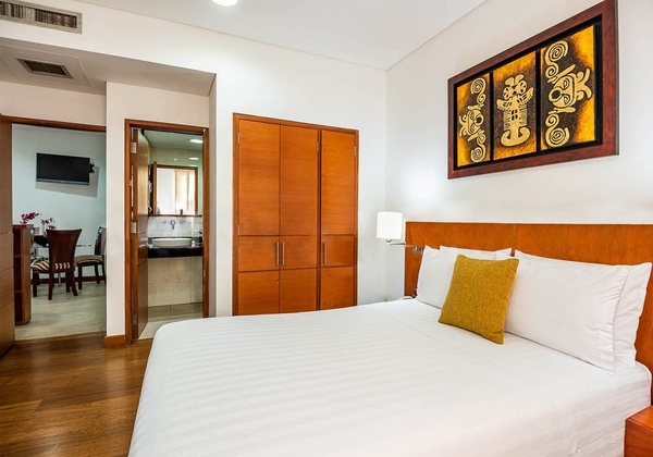a hotel room with a bed and a painting on the wall