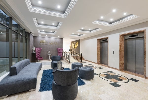 a hotel lobby with a couch chairs and elevators