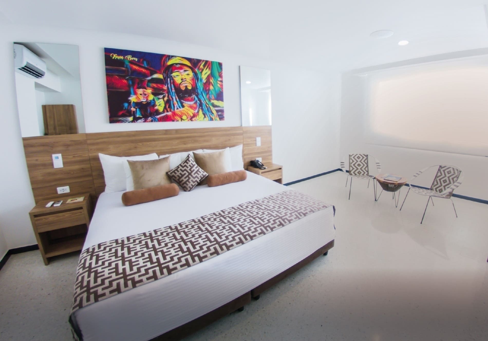 a painting of a man with dreadlocks is above a bed in a hotel room