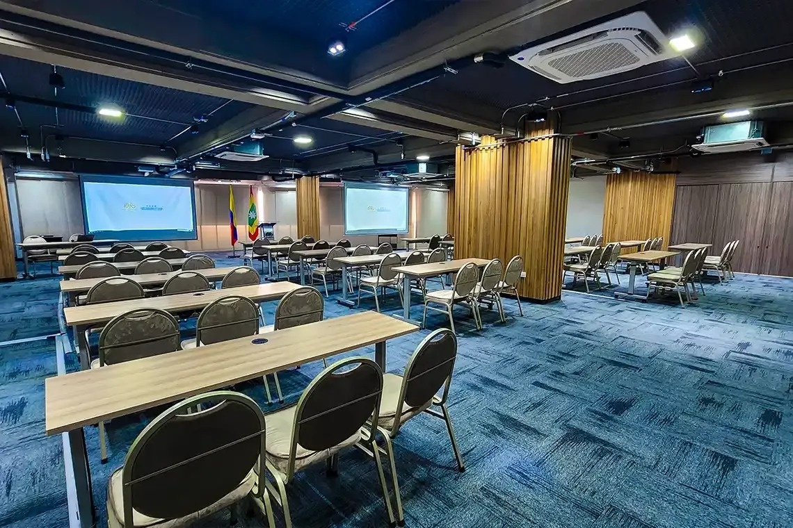 una sala de conferencias llena de mesas y sillas