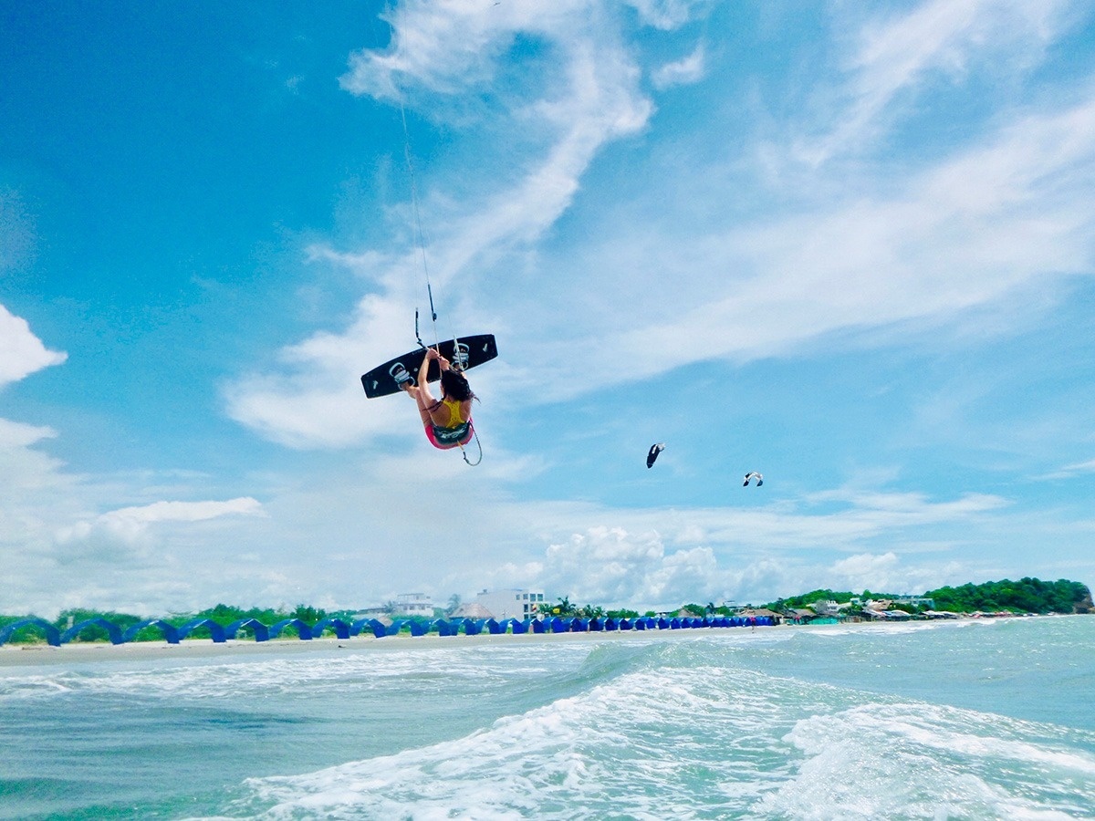 a person is flying through the air while holding a surfboard