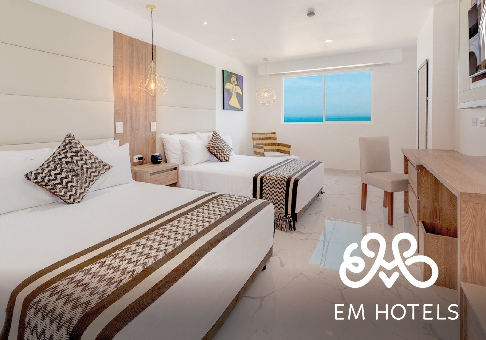 a hotel room with two beds and a sign that says em hotels