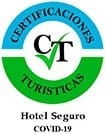 el logotipo del hotel seguro covid-19 está en un círculo verde y azul .