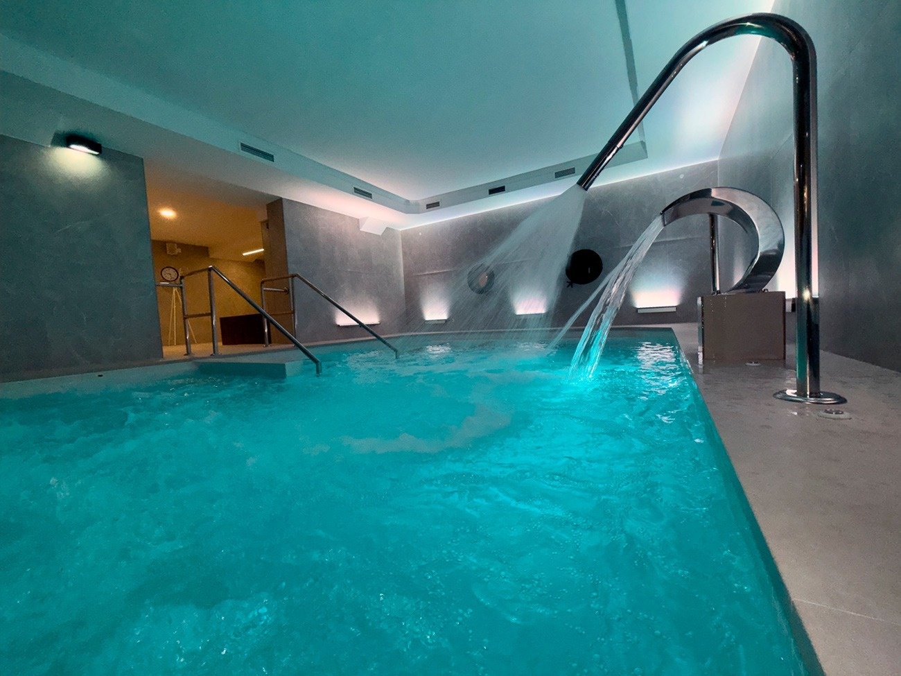 a man and a woman sit at a table under an umbrella