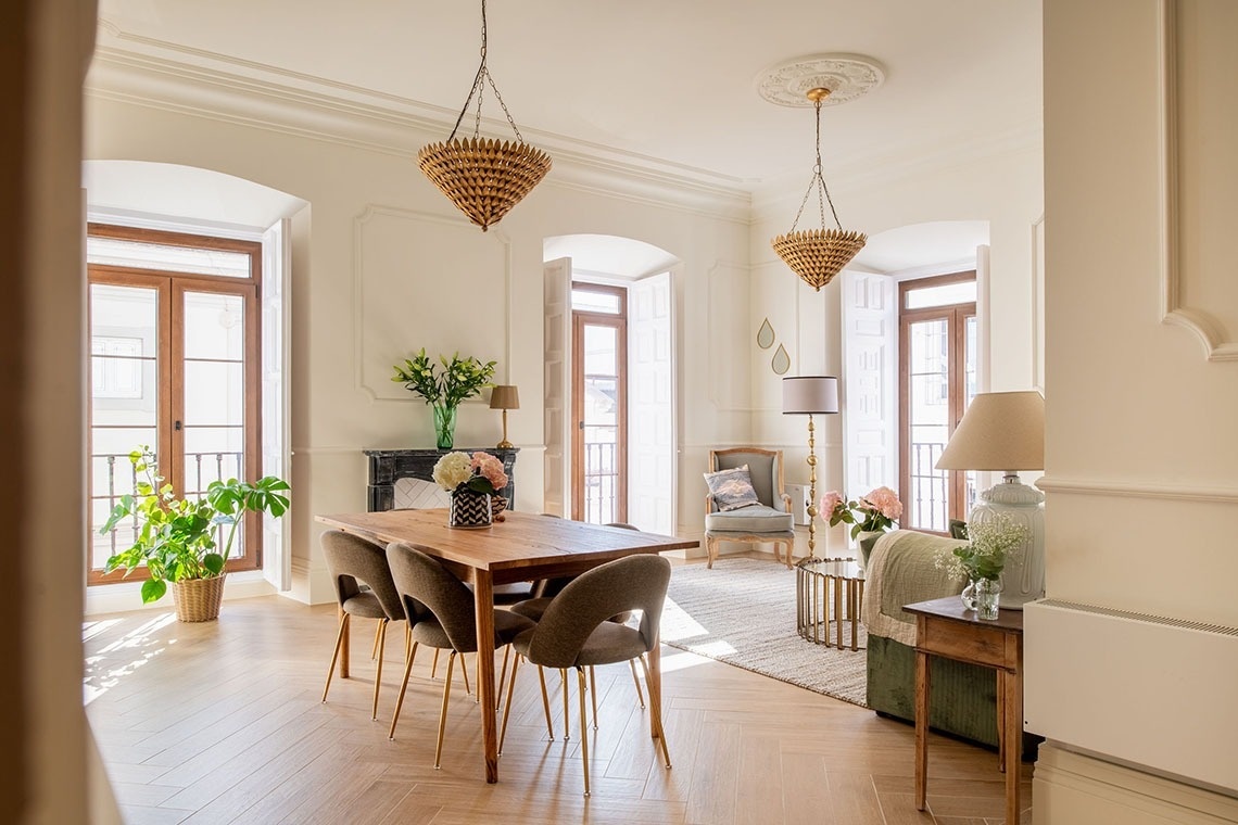 a living room with a dining table and chairs