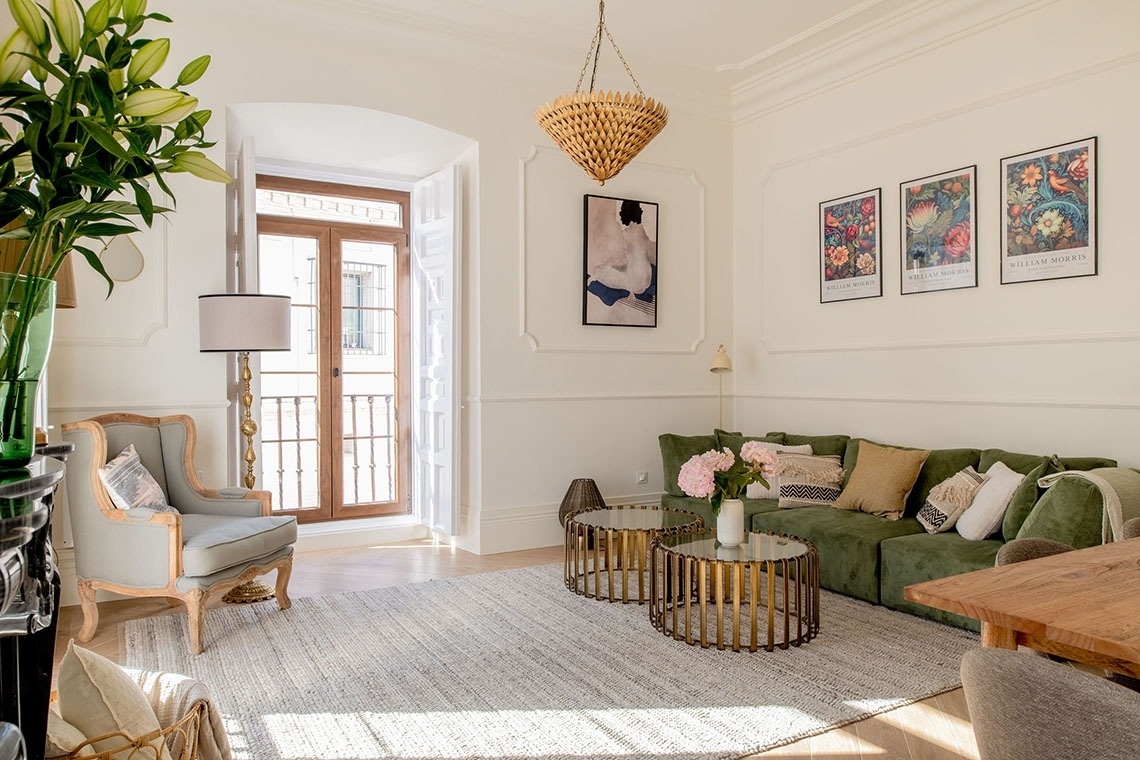 a living room with a green couch and a chair