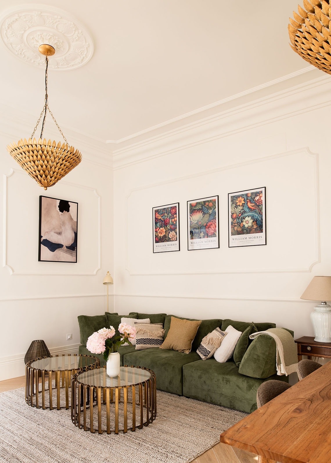 a living room with three william morris posters on the wall