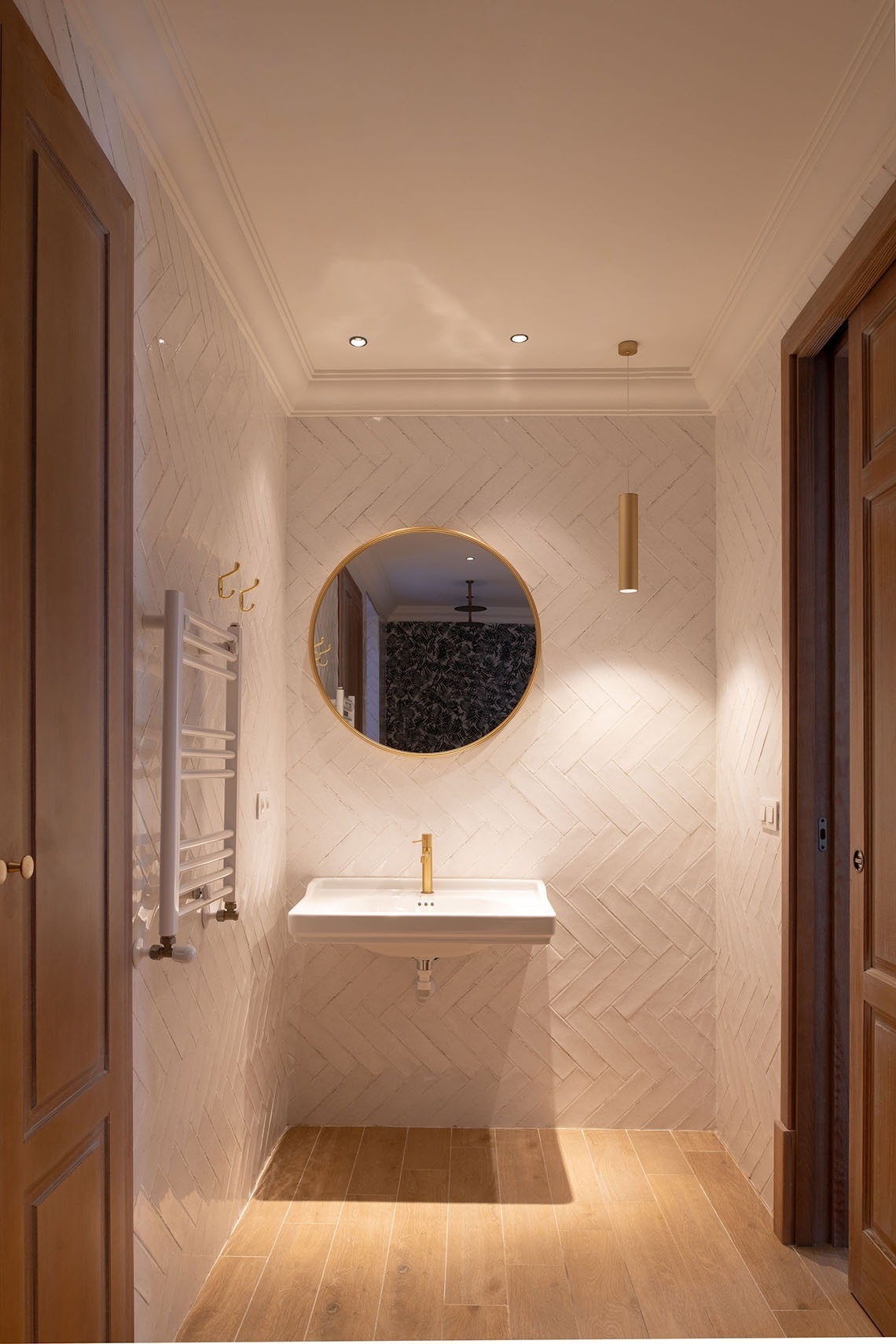 a bathroom with a sink and oval mirror