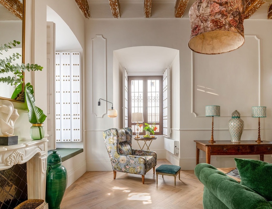 a living room with a chair and a green couch