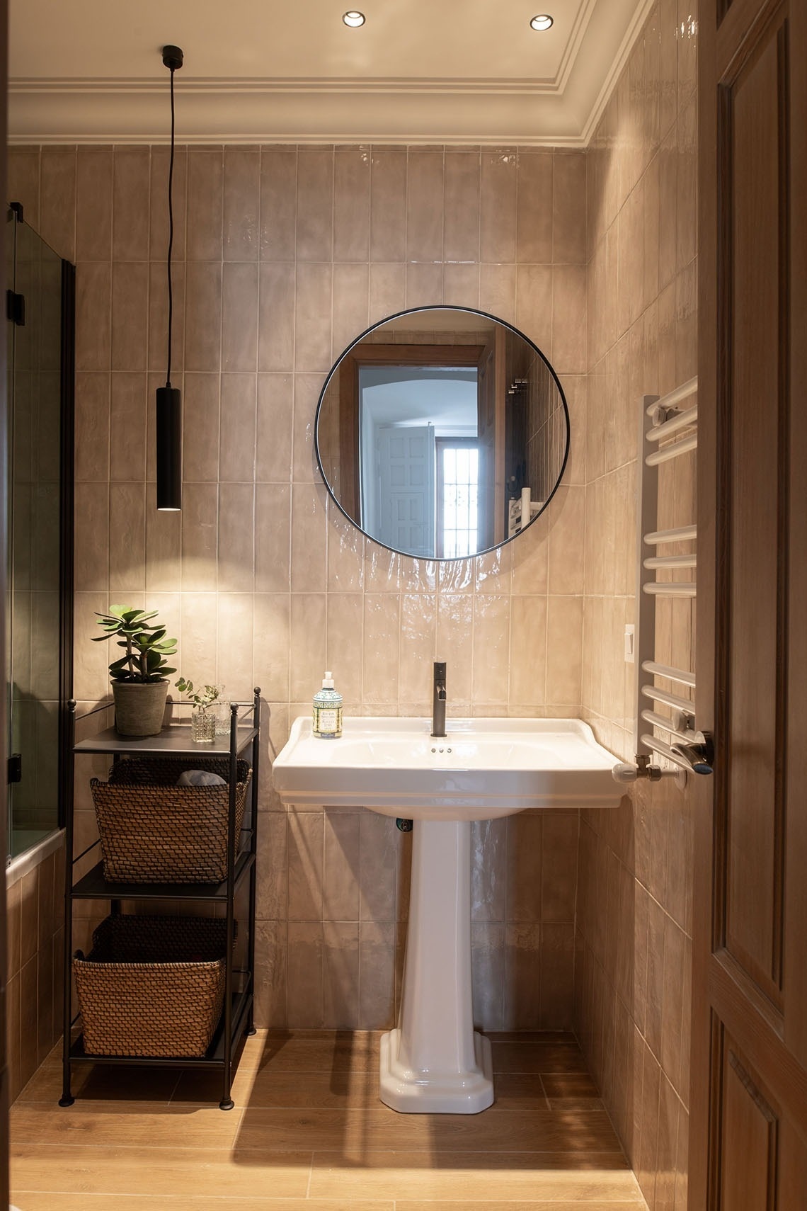 a bathroom with a pedestal sink and a mirror