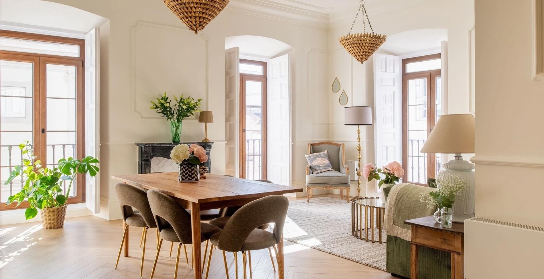 a living room with a wooden table and chairs