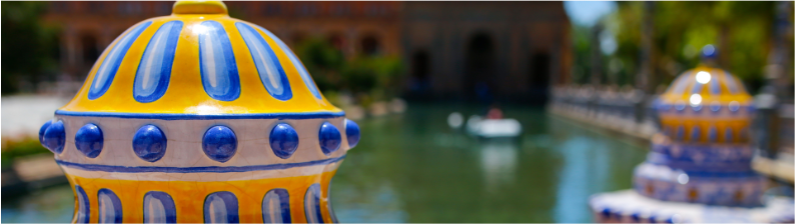 a close up of a yellow and blue object in front of a body of water
