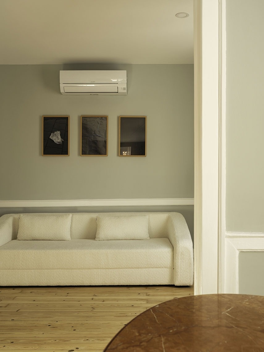 Cozy sofa and air conditioning at Esqina Apartments.