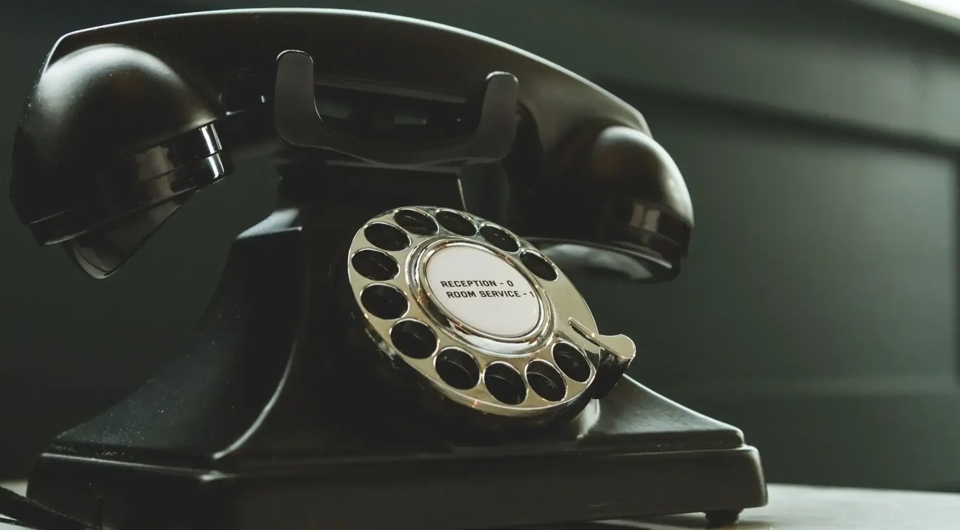 a black telephone with the words reception room service on it