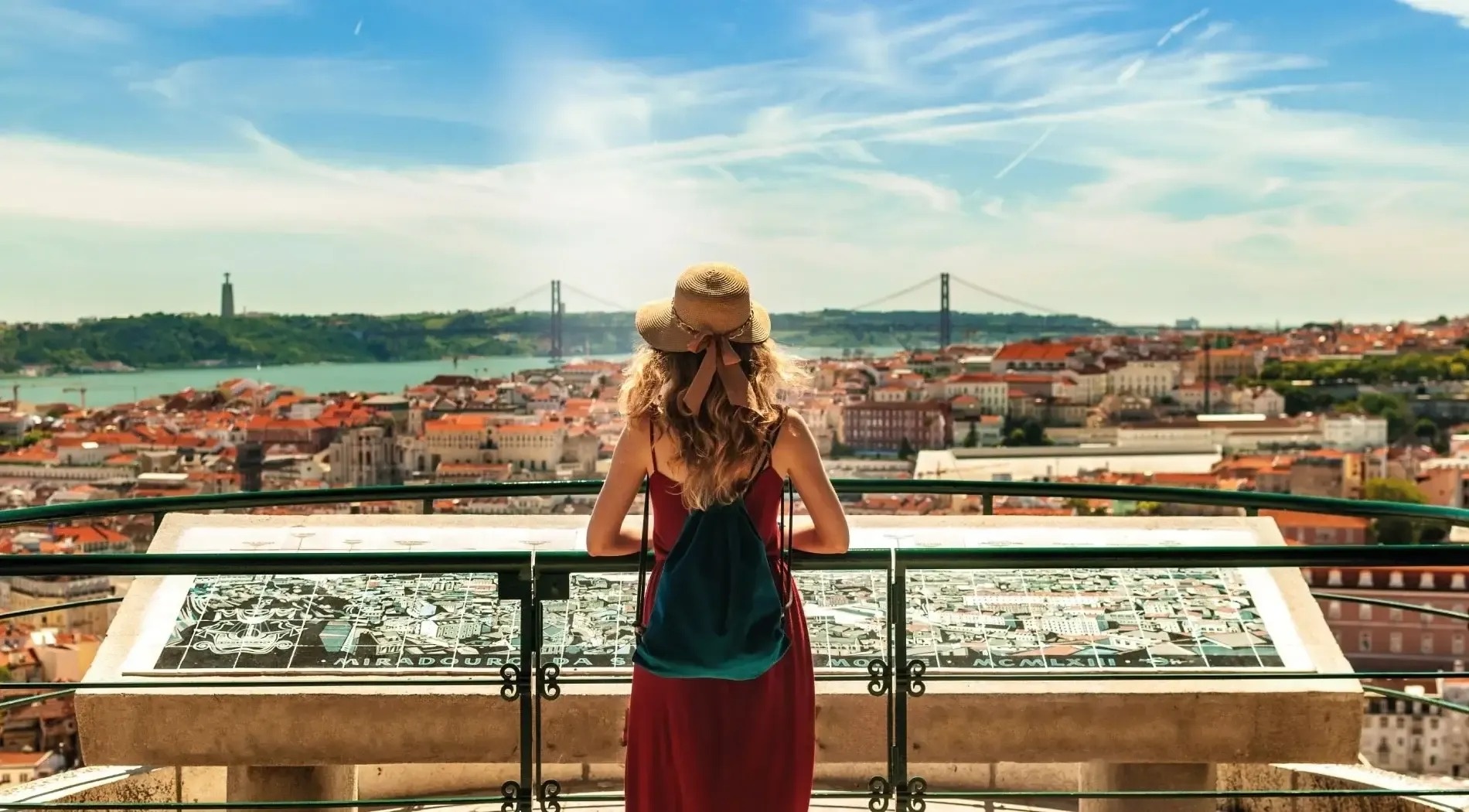 a woman in a red dress is looking out over a city