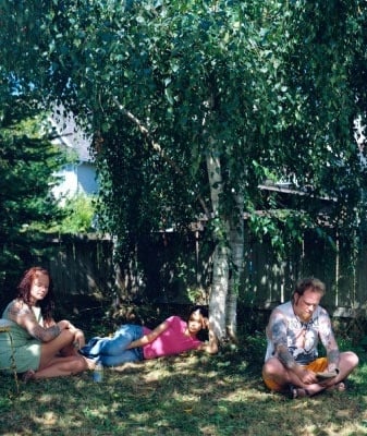 a man and a woman are sitting on the floor looking at pictures .