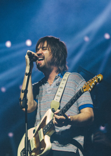 a crowd of people are standing in front of a stage at a concert .