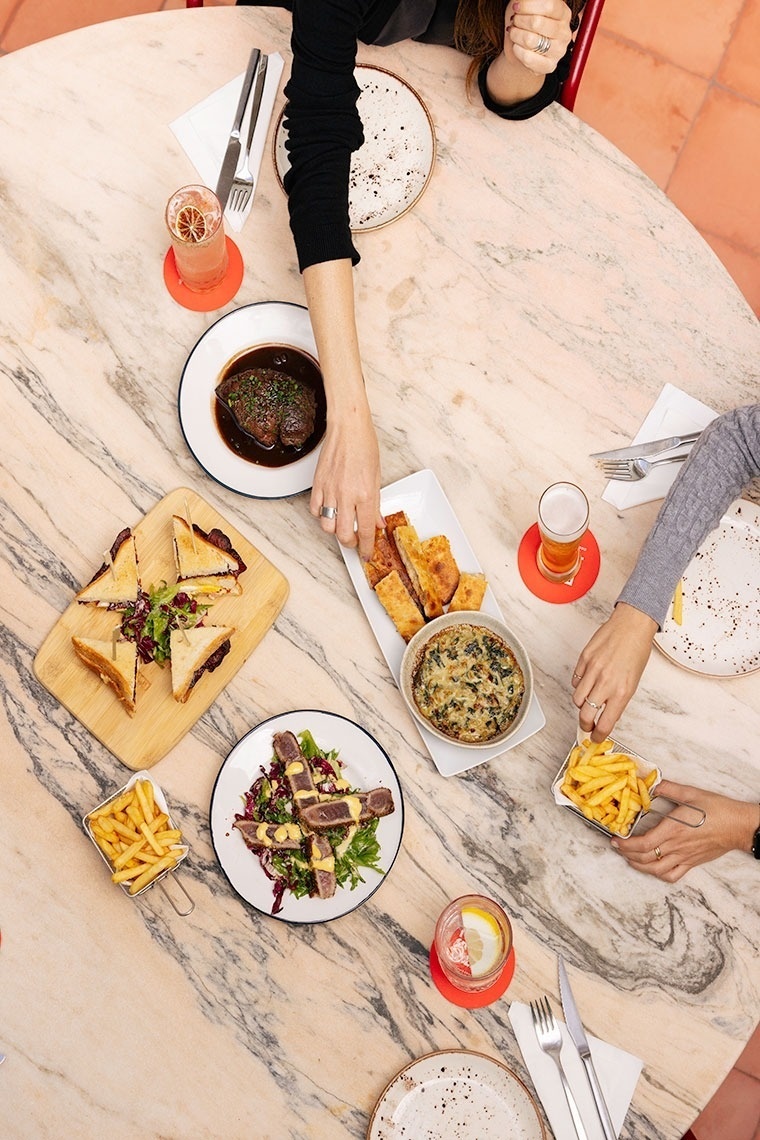 a table with plates of food and drinks on it