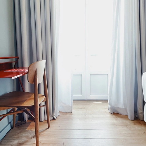 a bedroom with a red desk and a chair