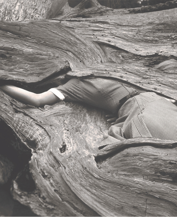 a black and white photo of a group of people in a bar with a coca cola sign on the wall
