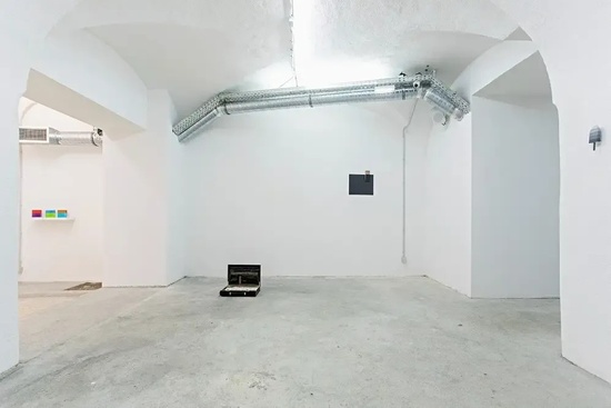 an empty room with a briefcase on the floor