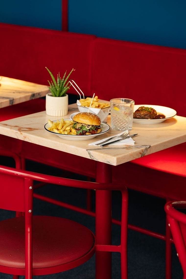 a table with a hamburger and french fries on it