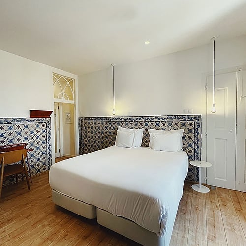 a hotel room with a bed and a desk
