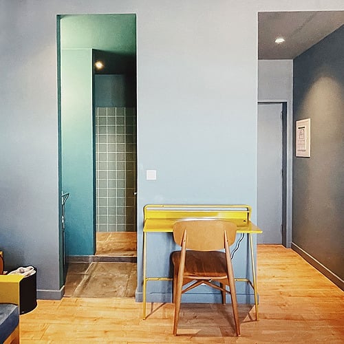 a room with a yellow desk and a chair