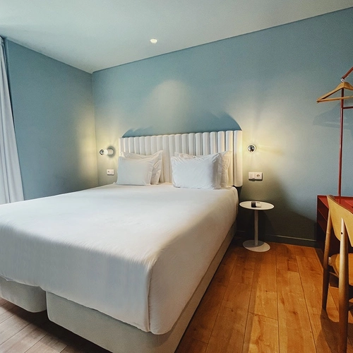 a hotel room with a bed and a desk