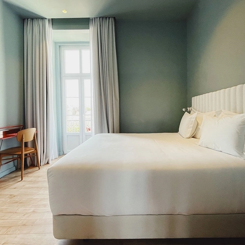 a bedroom with a king size bed and a desk